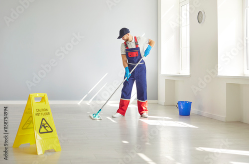 Man performs mopping floor duties as a cleaner, using a mop to clean floors as part of housekeeping service. Cleanup role showcases the essentials of housekeeping and cleaning service work. photo