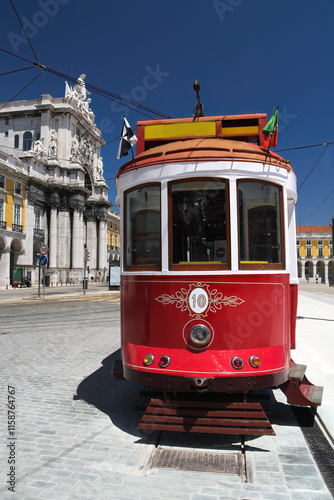 Lisbon view of the vintage Red Tram with the Triumphal Arch of the main square Praca do Comercio photo