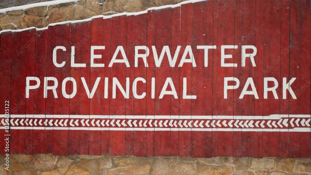 A close snow filled view of a wooden sign naming a provincial park