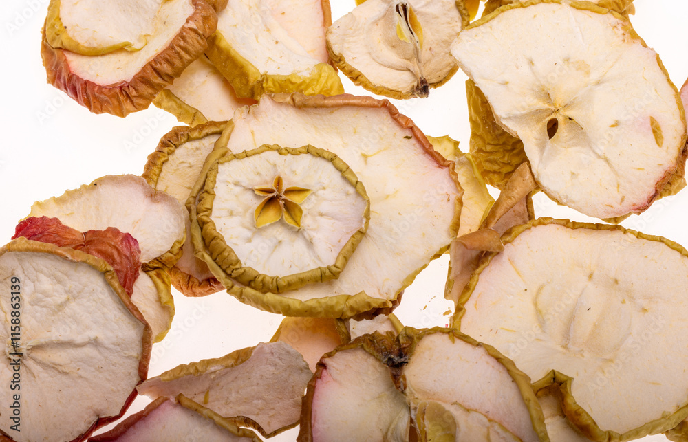 Closeup a pile of dried apple slices isolated on a white background. Healthy raw vegetarian eat from thin fruit chips of sweet and sour flavor
