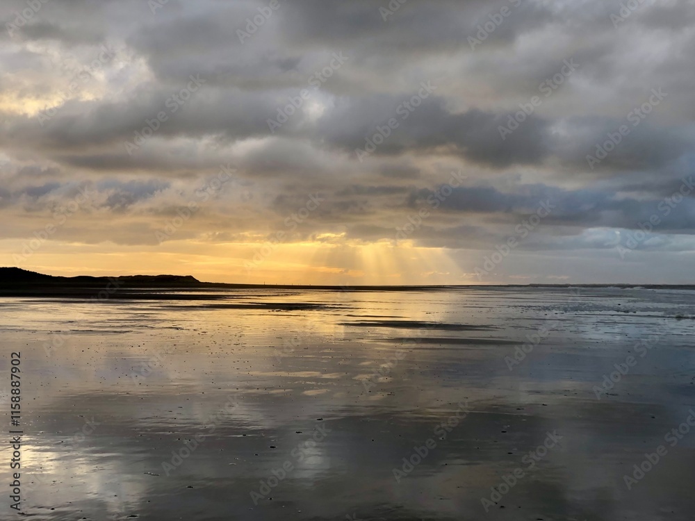 Sunbeams through clouds at the beach Sunbeams through clouds at the beach