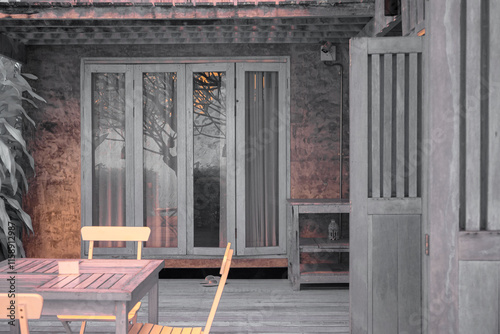 Infrared photography,  a wooden structure, likely a small house or cottage, with large glass doors leading to an outdoor area photo