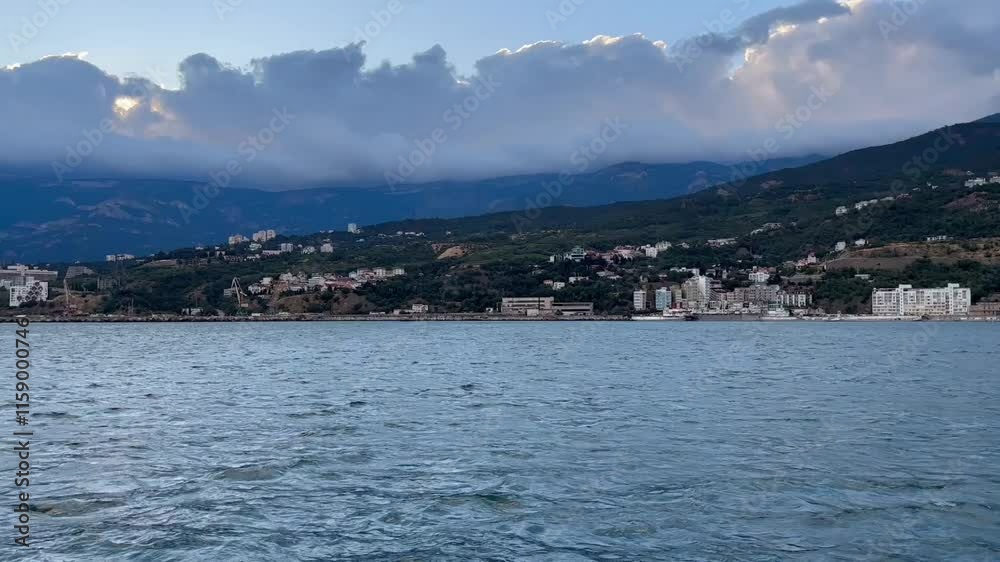View from the sea to Yalta city at sunset. Crimea View from the sea to Yalta city at sunset. Crimea