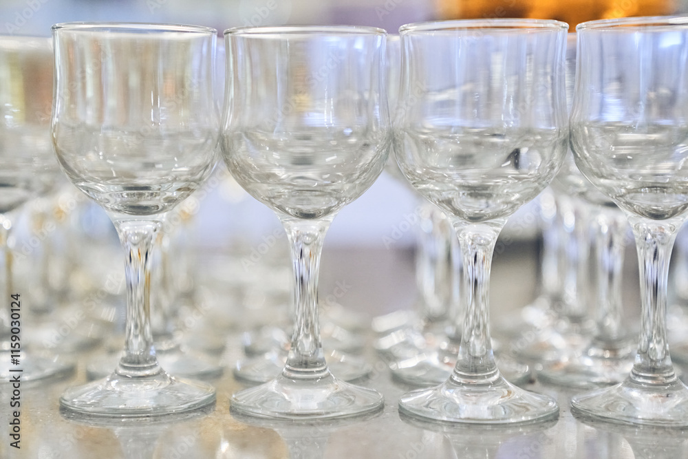 A row of empty, clear, clean wine glasses. Close-up with space to copy. High quality photo A row of empty, clear, clean wine glasses. Close-up with space to copy. High quality photo