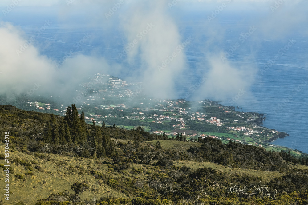 Aerial view of the clouds over Pico island Azores Portugal green mountains and meadows Aerial view of the clouds over Pico island Azores Portugal green mountains and meadows
