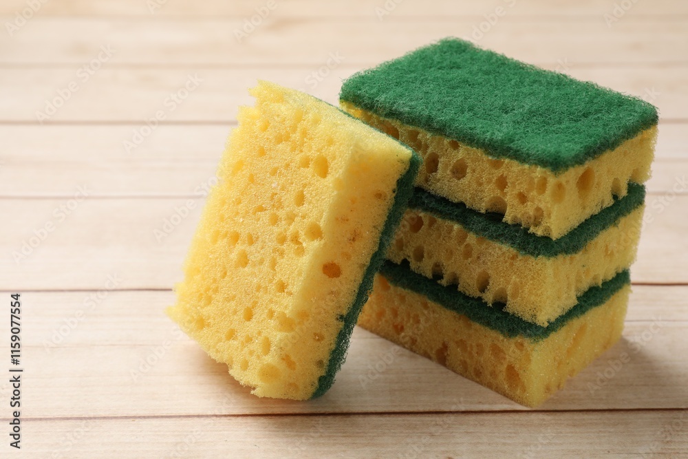 Many soft sponges on wooden table, closeup Many soft sponges on wooden table, closeup