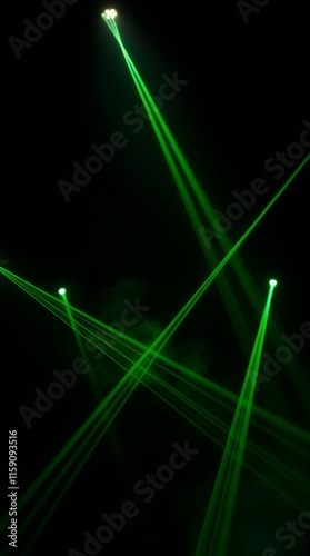Green laser lights pointing in different directions, with smoke in a dark space. Club, Party, Event, Music Concept. Vertical for background.