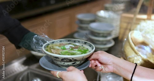 serve buy phobo soup Pho Bo vietnamese Soup with beef and chopsticks in male hand cousine asian photo