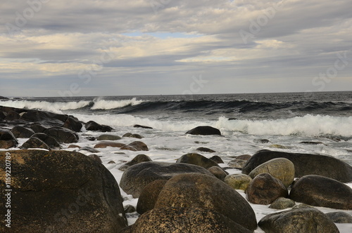 Stormy weather, Waves crashing on a rocky beach.