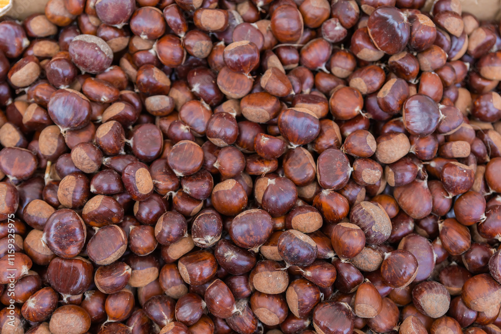 Raw sweet chestnuts in container at fruit-vegetable market Raw sweet chestnuts in container at fruit-vegetable market