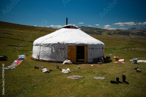 Mongolian Kazakh family lives in the Yurt Ger in between the mountains, lakes, rivers in green pasture on Altai mountains in Western mongolia