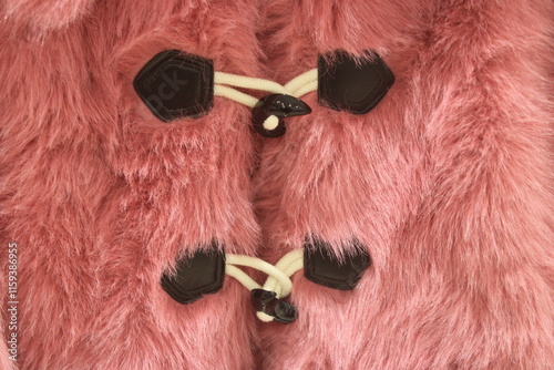 Closeup to fastened front of a pink faux fur coat