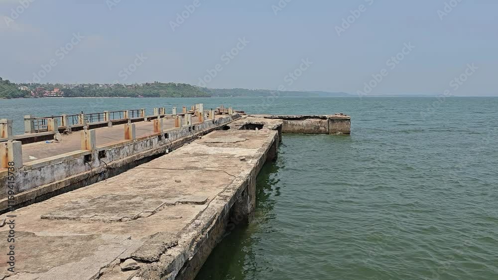 The Dona Paula viewpoint A concrete pier extending into the water, likely part of an old or functional dock. The Dona Paula viewpoint A concrete pier extending into the water, likely part of an old or functional dock.