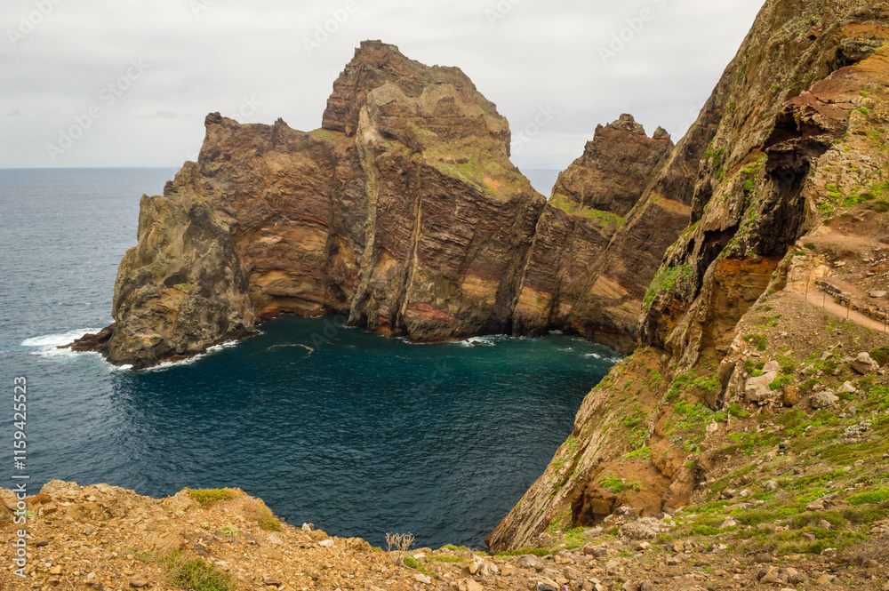 The majestic cliffs surrounded by blue waters. Vereda da Ponta de Sao Lourenco, Madeira, Portugal The majestic cliffs surrounded by blue waters. Vereda da Ponta de Sao Lourenco, Madeira, Portugal