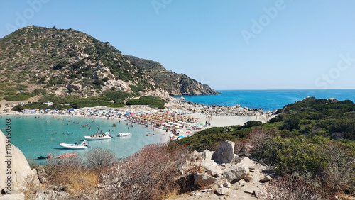 Beach in Villasimius, Cagliari, on the southeast tip of Sardinia Island, Italy. The idyllic isthmus of Punta Molentis with white sand and stones of the old granite quarry.