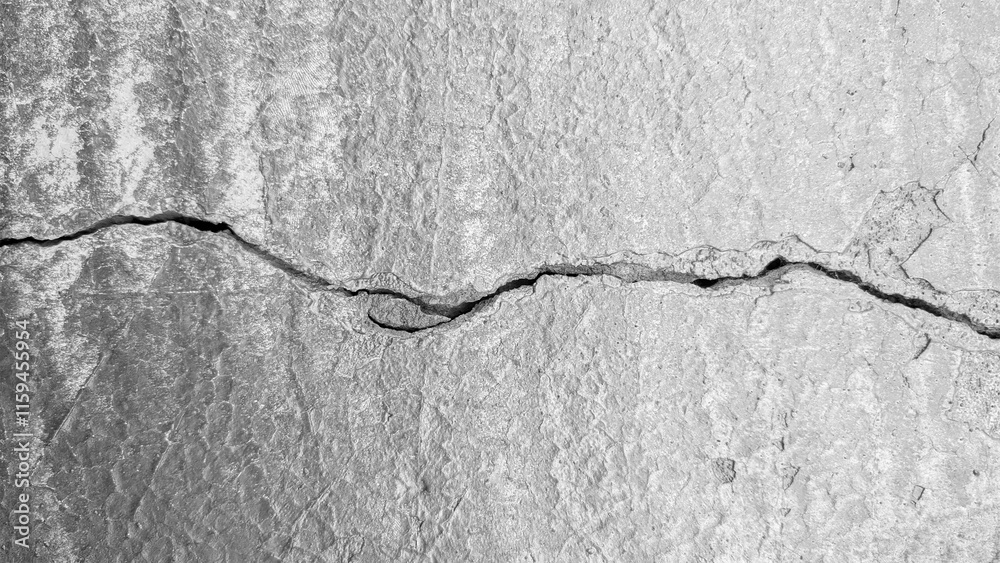 Obraz premium Old cracked concrete wall. Black and white background. Cracked concrete wall. Crack wall texture.
