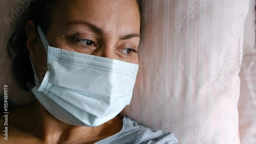 woman patient in mask lying in bed