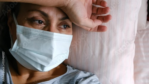 woman patient in mask lying in bed