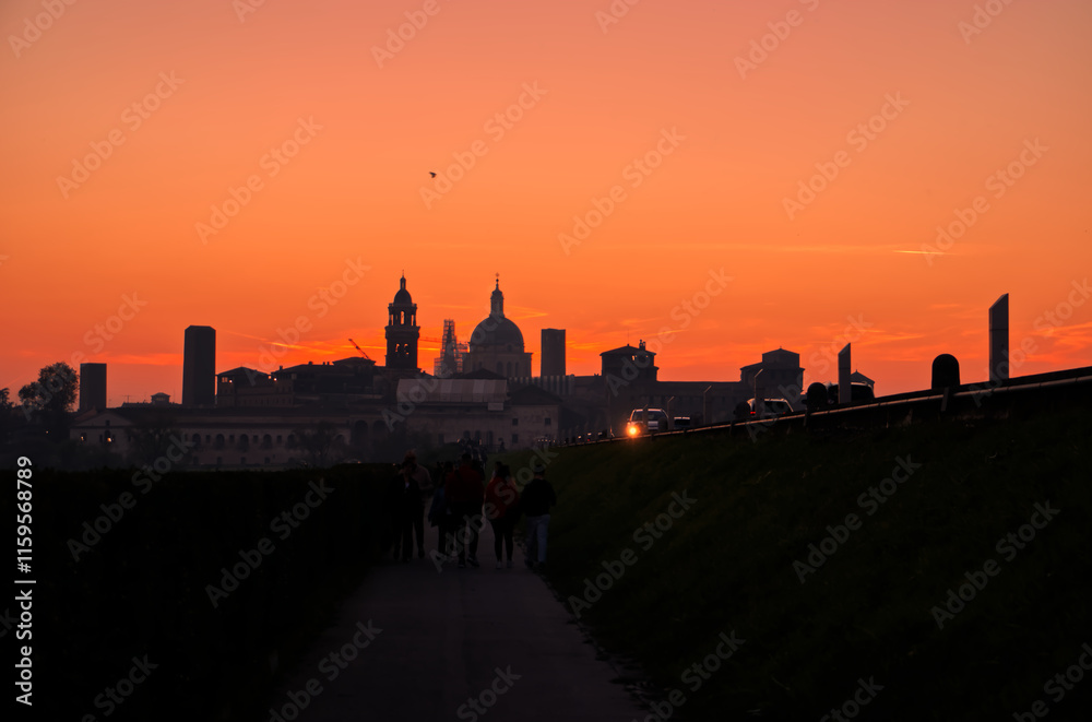 Obraz premium People walking at sunset in Mantova.