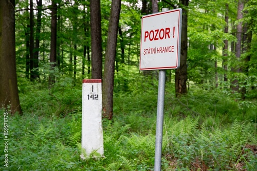 Obraz na płótnie Warning sign BEWARE, NATIONAL BORDER written in Czech with border stone w salonie