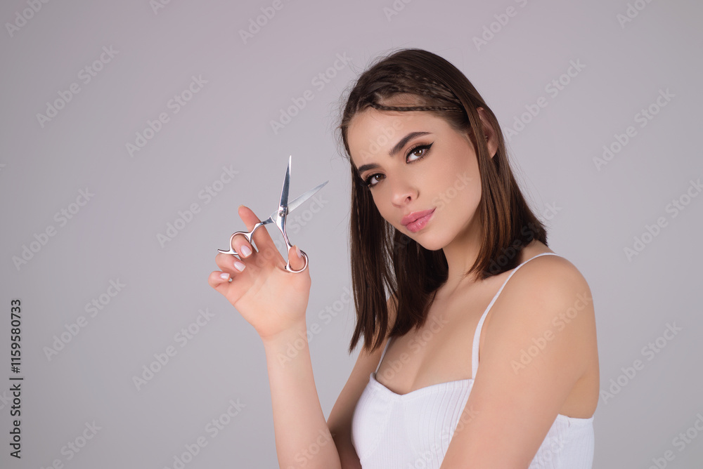 Beauty woman cutting hair with scissors isolated on studio background. Beautiful girl about to cut hair. Hair cut scissors concept. Hairdresser scissors change hairstyle. Hair model hold scissors. Beauty woman cutting hair with scissors isolated on studio background. Beautiful girl about to cut hair. Hair cut scissors concept. Hairdresser scissors change hairstyle. Hair model hold scissors.