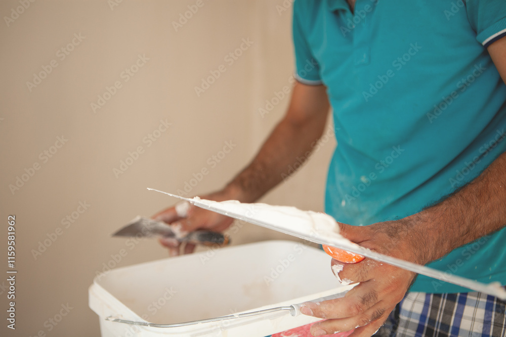 Obraz premium man with a roller brush