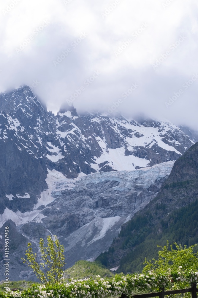 Beautiful landscape in the Alps. Mountain landscape with cloudy sky in summer in northern Italy. Mountain ranges and glaciers. Beautiful landscape in the Alps. Mountain landscape with cloudy sky in summer in northern Italy. Mountain ranges and glaciers.