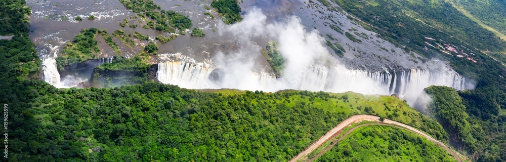Seen from the air the mighty Zambezi River stretching wide upstream plummets into a dramatic gorge, creating one of the largest waterfalls in the world, Victoria Falls