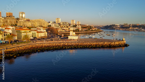 Vista capturando a deslumbrante paisagem do Porto e de Matosinhos, onde o Rio Douro encontra o Oceano Atlântico. A cena apresenta as areias douradas da praia de Matosinhos,  photo