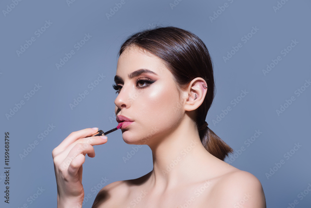 Beautiful young woman applying red lipstick on lips, studio color background. Sexy girl applied lipstick. Young nodel holding pink lipstick. Red lips make up. Beautiful woman putting lipstick on lips. Beautiful young woman applying red lipstick on lips, studio color background. Sexy girl applied lipstick. Young nodel holding pink lipstick. Red lips make up. Beautiful woman putting lipstick on lips.