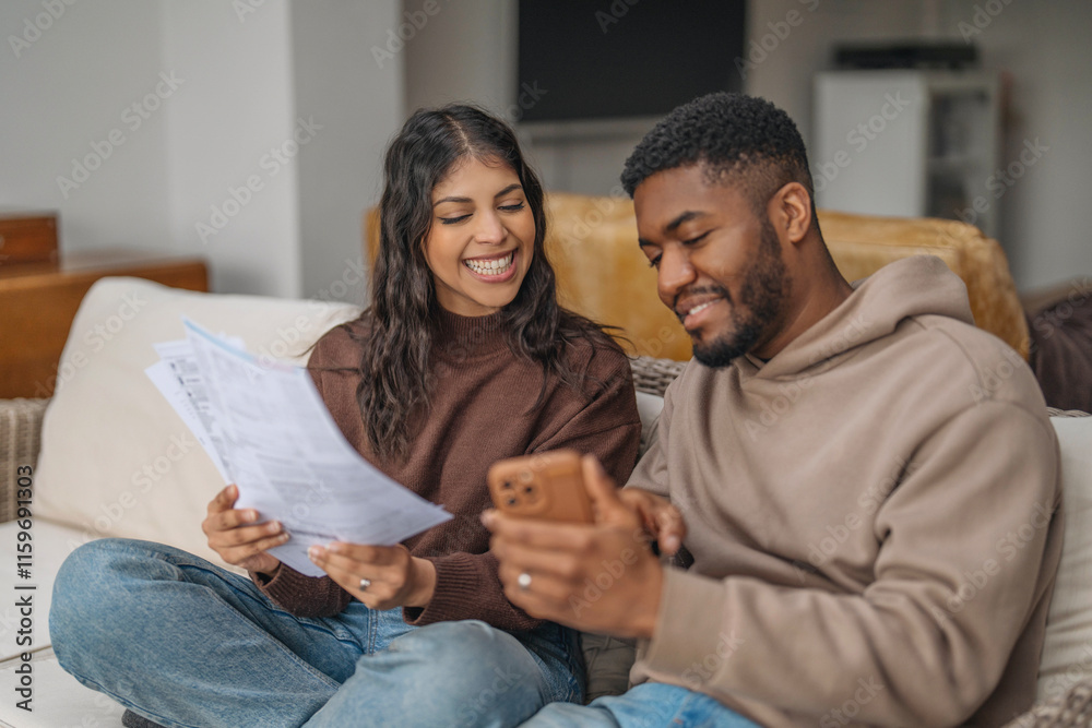 Couple enjoys a cozy afternoon together while reviewing documents and sharing moments on their smartphone Couple enjoys a cozy afternoon together while reviewing documents and sharing moments on their smartphone