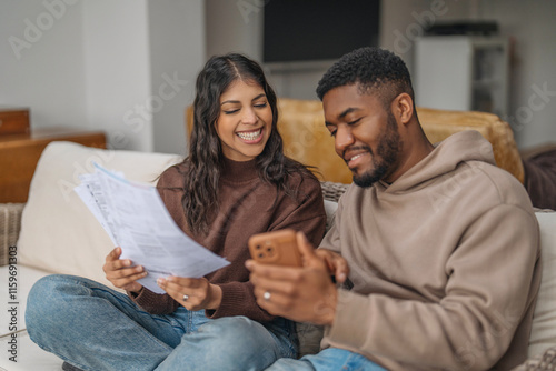 Couple enjoys a cozy afternoon together while reviewing documents and sharing moments on their smartphone