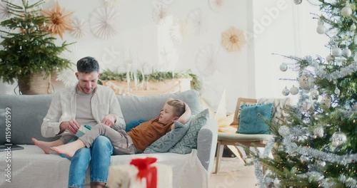 Young Boy Gives Dad a Christmas Present photo