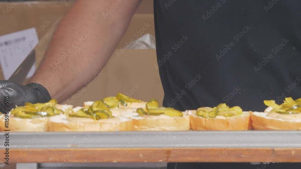 Preparing trendy American smash burgers or cheeseburgers. Soft buns, pickles, onions and sauce are waiting for the parties to be served. Street food festival. Preparing trendy American smash burgers or cheeseburgers. Soft buns, pickles, onions and sauce are waiting for the parties to be served. Street food festival.