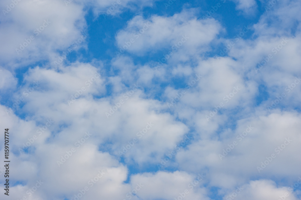 Bright blue sky dotted with fluffy white clouds on a sunny day Bright blue sky dotted with fluffy white clouds on a sunny day