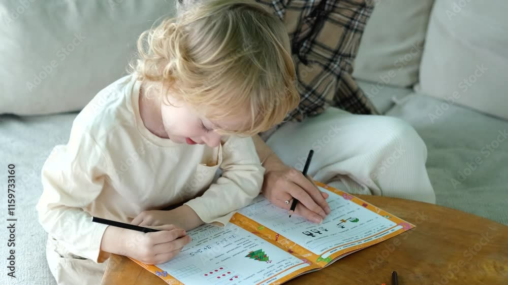close-up mom helps her son do his schoolwork at home