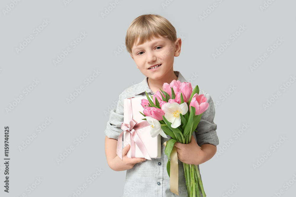Cute little boy with bouquet of beautiful tulips and gift box on grey background. International Women's Day Cute little boy with bouquet of beautiful tulips and gift box on grey background. International Women's Day