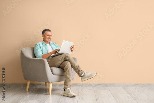 Old man with laptop sitting...