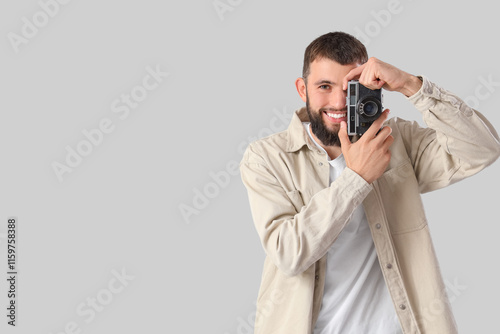 Young bearded man with phot...