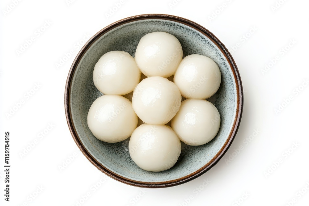Aerial view of large glutinous rice dumplings in a bowl set against a white background for the Lunar New Year celebration Aerial view of large glutinous rice dumplings in a bowl set against a white background for the Lunar New Year celebration