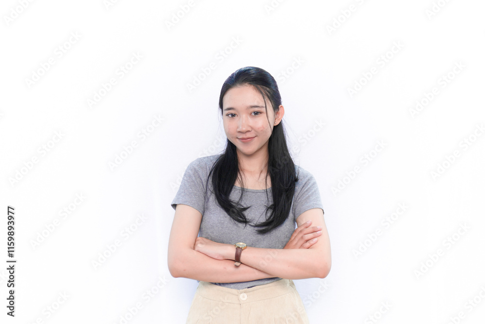 Asian Indonesian woman in gray shirt smiling and crossing her arms Asian Indonesian woman in gray shirt smiling and crossing her arms
