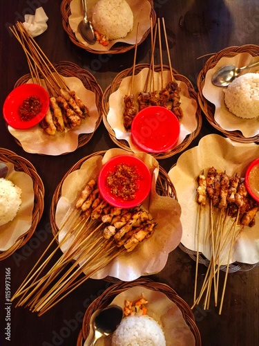 Taichan satay or taichan satay, made from chicken, served on a rattan plate with sauce, soy sauce and lime. this food is like yakitori photo