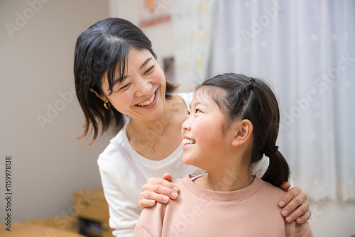 фотографія Mother praising daughter Close-up of good friends smiling as they stare at each