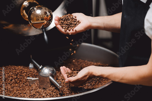 Closeup view of roasted coffee beans in mans hand. Food industry business coffeeshop