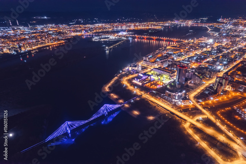 Aerial top view city Krasnoyarsk bridge through Yenisei river evening with neon light photo