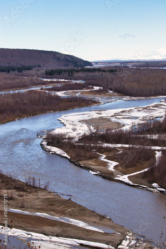 Snow on land next to the Tanana River on a sunny spring day in Alaska.