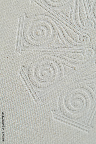 White linen texture with an embossed design. 
