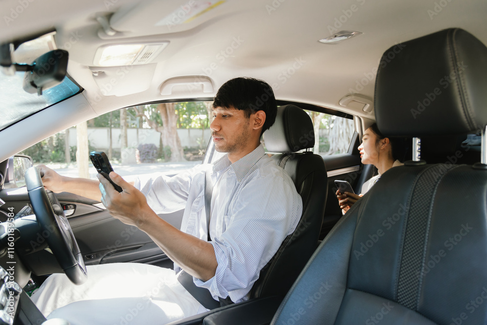 Confident young man in car, smiling while using phone for navigation. This image shows a fun journey, modern lifestyle and the positive energy of travel. Service Confident young man in car, smiling while using phone for navigation. This image shows a fun journey, modern lifestyle and the positive energy of travel. Service