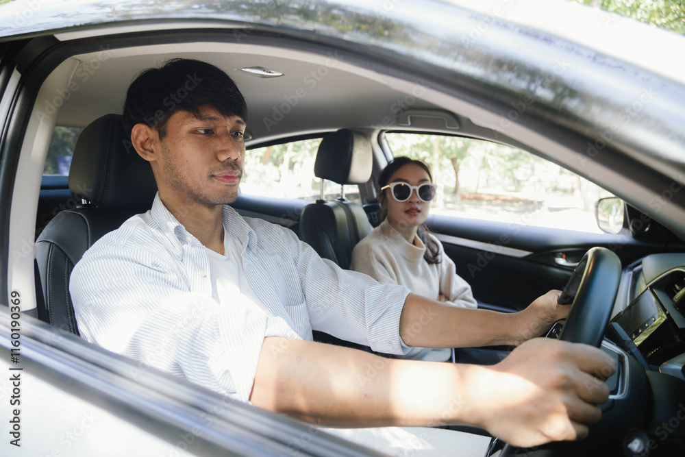 Confident young man in car, smiling while using phone for navigation. This image shows a fun journey, modern lifestyle and the positive energy of travel. Service Confident young man in car, smiling while using phone for navigation. This image shows a fun journey, modern lifestyle and the positive energy of travel. Service
