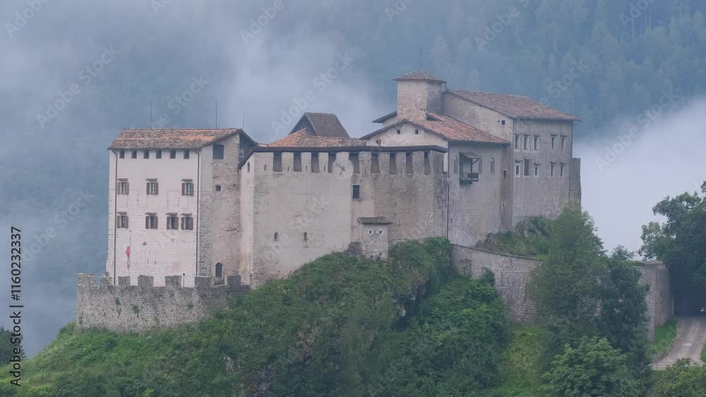 Castello di Stenico, Italy – Slow Motion 4K Video of Morning Fog, Low Clouds, and High Mountain Views Surrounding the Historic Castle Castello di Stenico, Italy – Slow Motion 4K Video of Morning Fog, Low Clouds, and High Mountain Views Surrounding the Historic Castle